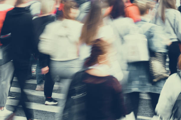 istock Blurred crowds of people walking around the city 1276702433