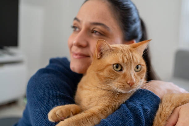 istock Woman with cat at home 1276703799