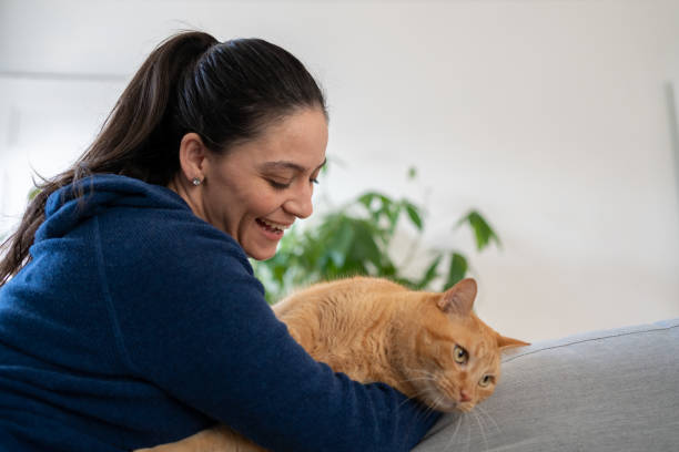 istock Woman with cat at home 1276703814