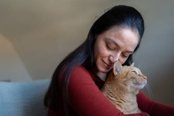 istock Woman with cat at home 1276703868