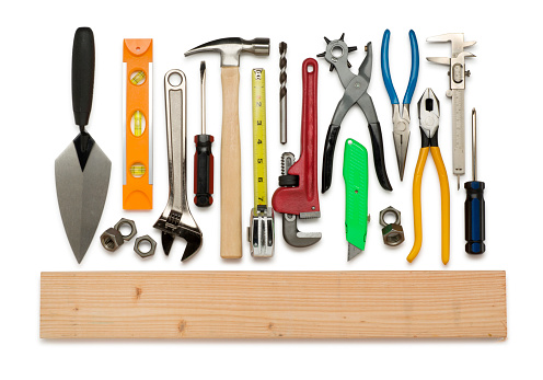 This is an overhead photo of construction tools isolated on a white background. There is a clipping path included with this file.