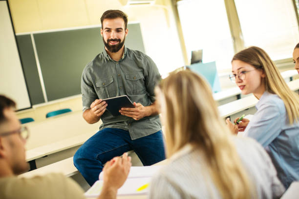 istock Young male student sitting in front of her class 1276704847