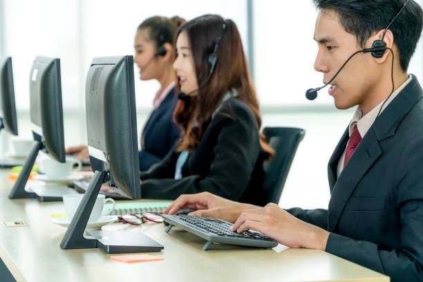 istock Business people wearing headset working in office 1276705640
