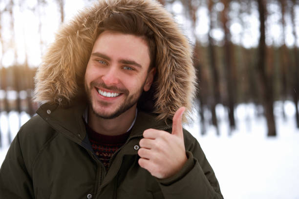 istock Attractive bearded man standing outdoors in winter season forest. 1276706024