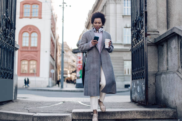 istock Stylish and urban lady going down the stairs 1276706649