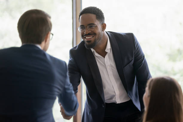 istock Smiling diverse businessmen handshake at meeting in office 1276706756
