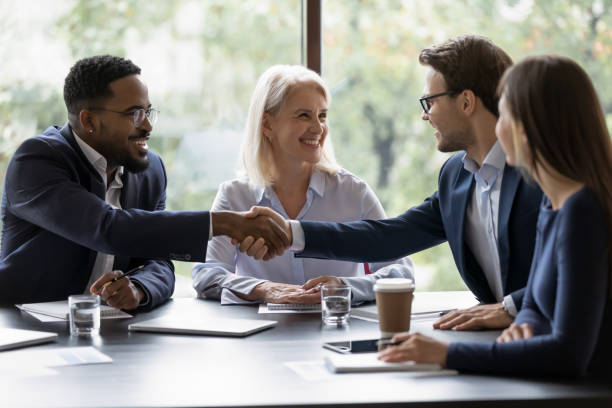istock Smiling diverse employees handshake at briefing in office 1276706759