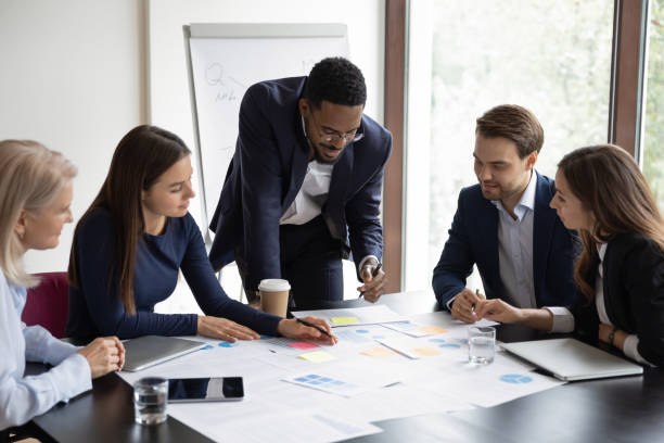 istock Multiethnic colleagues brainstorm at team meeting in office 1276706787