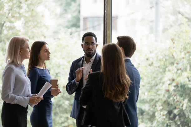 istock Diverse colleagues talk brainstorm at casual office meeting 1276706791
