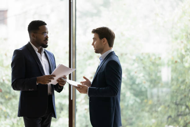 istock Diverse male business partners discuss paperwork in office 1276706798