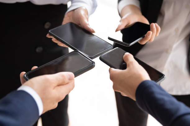 istock Close up of diverse businesspeople using smartphones 1276706808