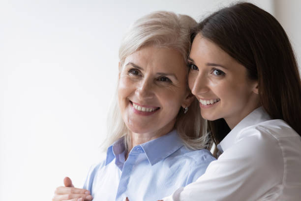 istock Smiling older mom and grownup daughter hugging 1276706826