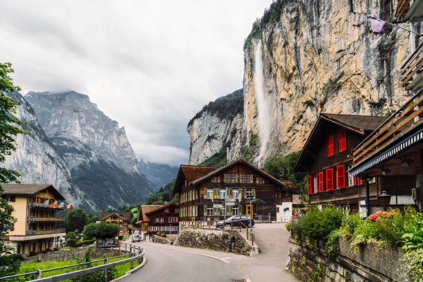 The Lauterbrunnen Valley, Switzerland with Staubbach waterfall falling over the stark rock cliff above town.