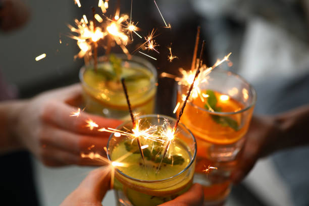 istock Young group friends hold in hand cocktail with sparkler 1276707156