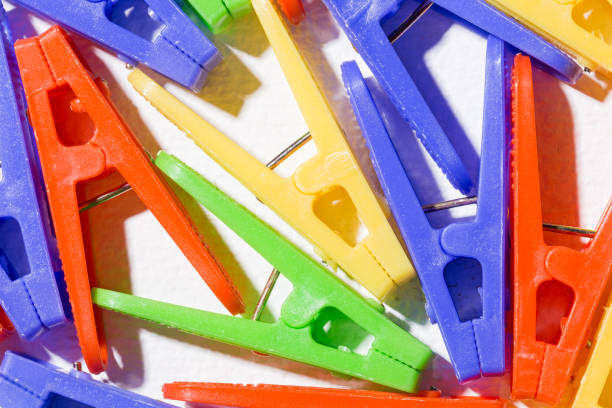 istock Colorful plastic clothespins for hanging clothes on white background 1276708079