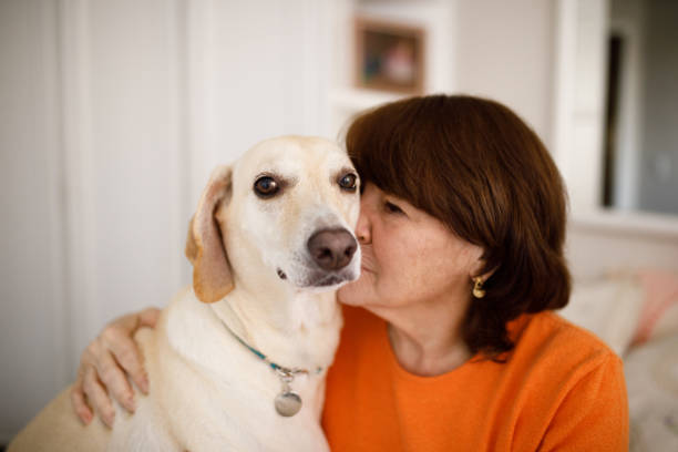 istock Senior woman sniffing her dog 1276711806