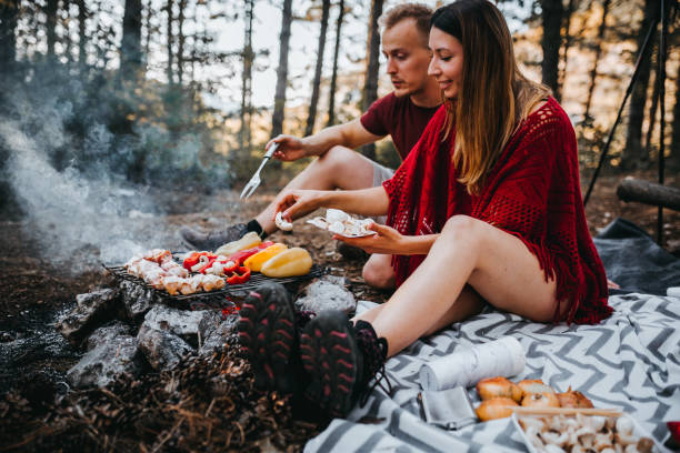 istock Couple Making Barbecue Picnic In The Woods 1276712825