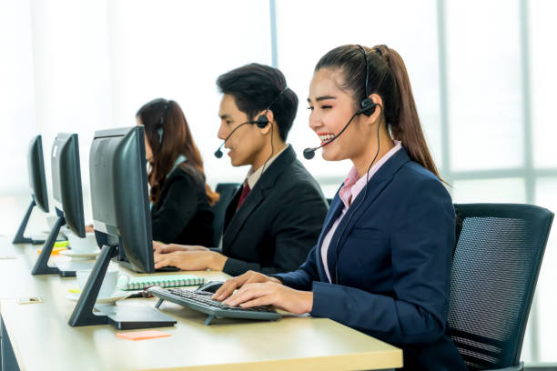 istock Business people wearing headset working in office 1276713987