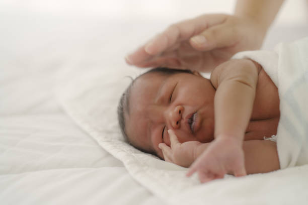 istock african american new born baby lying on white bed 1276714665