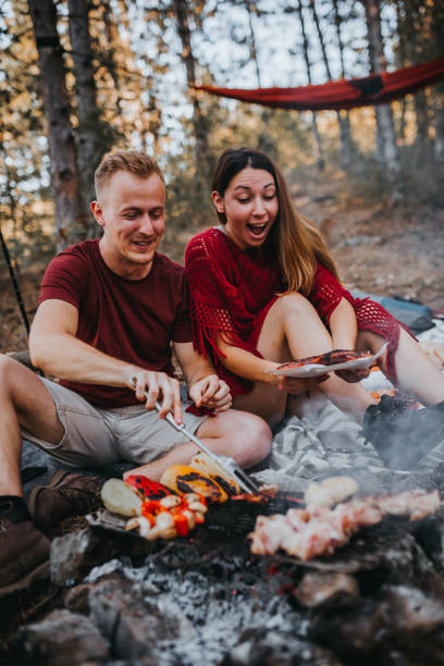 istock Couple preparing a food in nature, campfire 1276717009