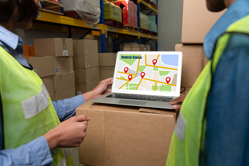 Warehouse management software application in computer for real time monitoring of goods package delivery . PC screen showing smart inventory dashboard for storage and supply chain distribution .