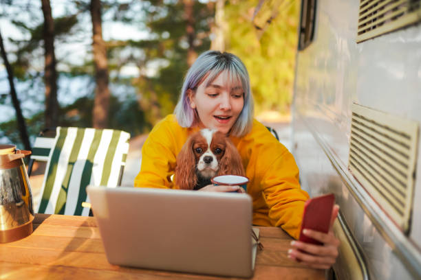Young Girl having video call at camp with her dog