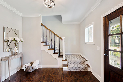 Front entryway with partially carpeted stairs