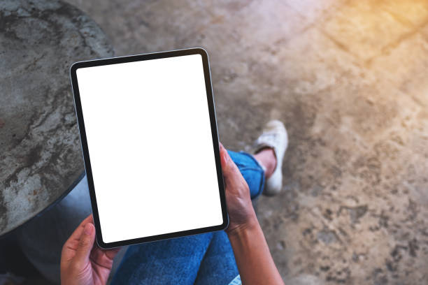 istock a woman holding digital tablet with blank white desktop screen 1276727988