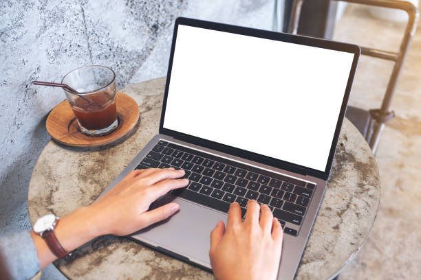 istock a woman using and typing on laptop computer keyboard with blank white desktop screen in cafe 1276727989