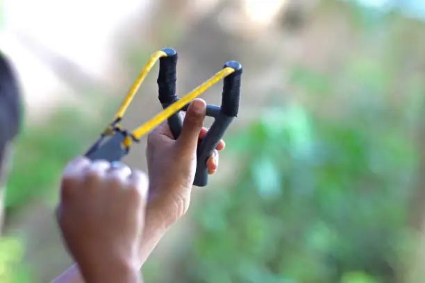 Little boy holding a Catapult