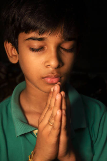 istock Indian Cute young boy praying 1276728890