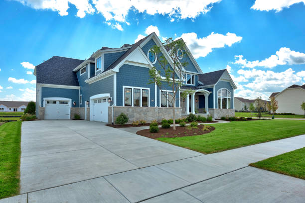 istock Large home with blue siding and three car garage 1276730613