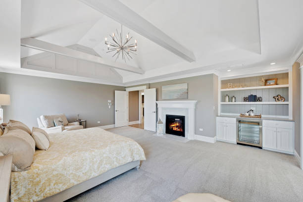 istock Gorgeous master bedroom with fireplace and beverage refrigerator 1276730620