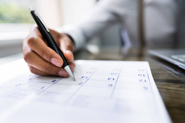 Calendar Deadline Calendar Deadline. Young Man Holding Pen Marking Date calendar date circled stock pictures, royalty-free photos & images