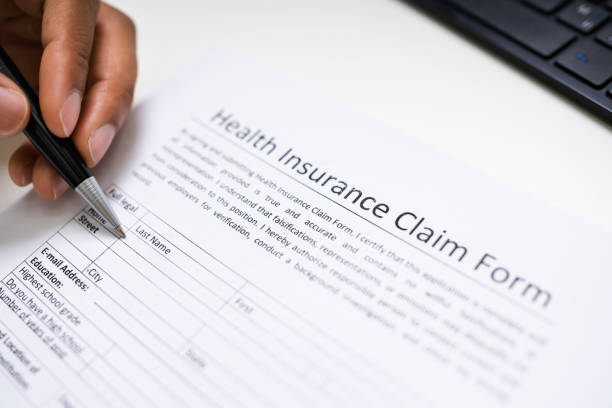 istock Writing Health Insurance Policy Paper 1276731807