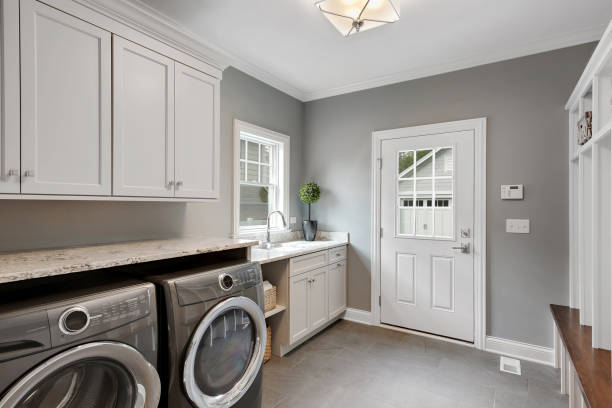 Perfect laundry room and mud room combination Large front loading washer and dryer in newly built home utility room stock pictures, royalty-free photos & images