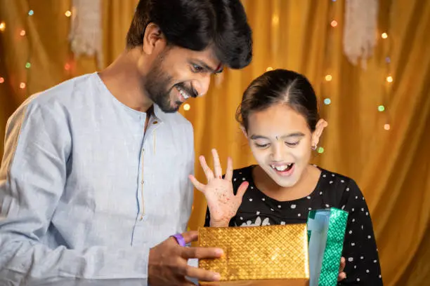 Excited little Sister got gift from her Bother during Raksha Bandhan, Bhai Dooj or Bhaubeej Indian religious festival ceremony