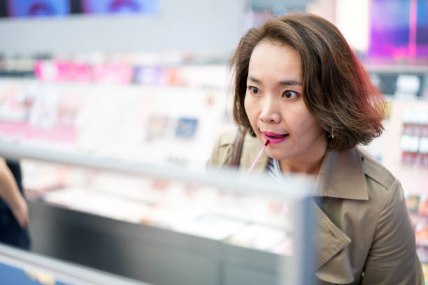 istock Young Asian women buying cosmetics 1276738475