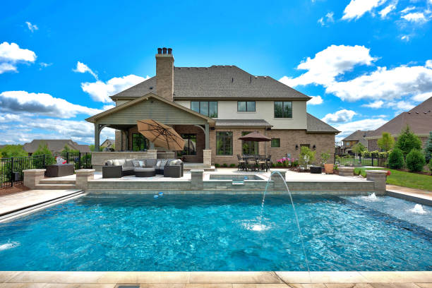 istock Big swimming pool with lounge chairs and water spray features 1276740256