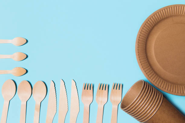 istock Eco friendly craft paper tableware on blue background. Recycling concept. 1276741484