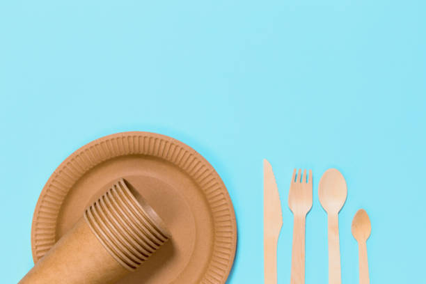 istock Eco friendly craft paper tableware on blue background. Recycling concept. 1276741485