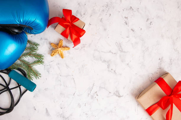 istock Boxing gloves, rope, gifts on a light concrete background. Top view, copy space for text. Christmas and healthy lifestyle concept. 1276743866