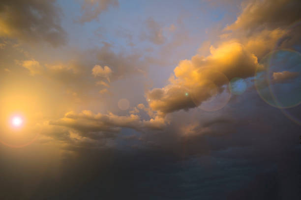 istock Orange stormy sunset with a clouds with a lens flare 1276744717