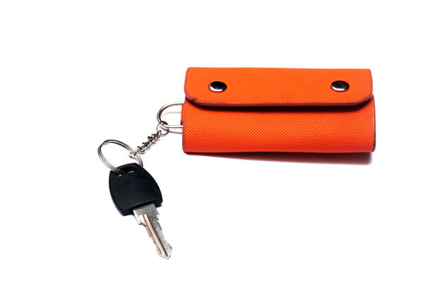 istock Key and orange case, isolated on white background 1276746029