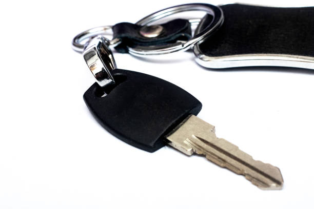 istock Key and black keychain, isolated on white background 1276746090