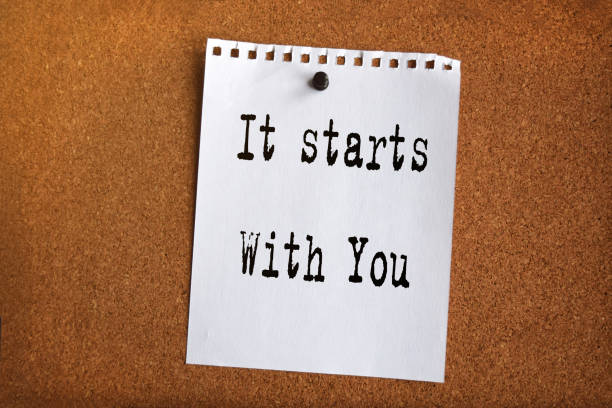 istock Paper note written with IT STARTS WITH YOU inscription on cork board 1276748345