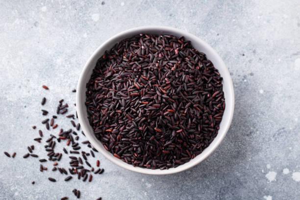 istock Black wild rice in a bowl. Grey stone background. Close up. Top view. 1276749244