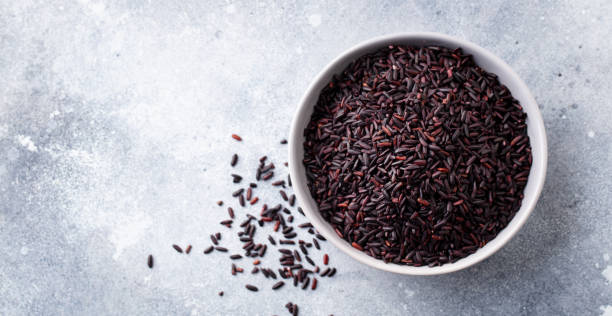 istock Black wild rice in a bowl. Grey stone background. Copy space. Top view. 1276749279