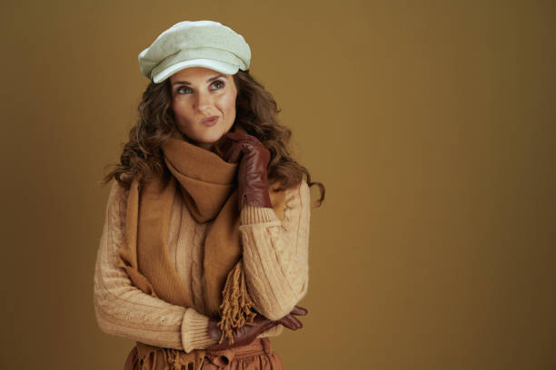 istock pensive elegant female in sweater isolated on beige background 1276752302