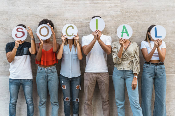 istock Group of young people from different countries people hiding their faces together with with the world âsocialâ. Concept of friendship, trust, teamwork, communication and social network. 1276754010